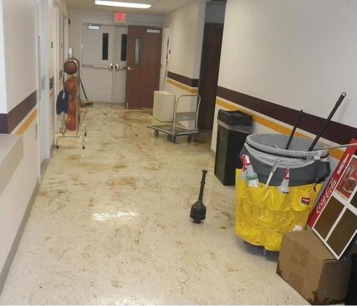 debris and sewage on resilient floor, hallway of a school