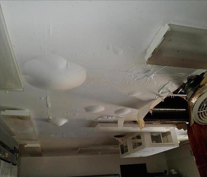 blister bubbles on ceiling from water damage, white 
