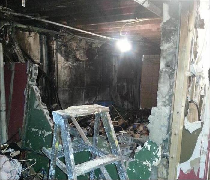 burned interior, destruction of cinder block walls in the basement