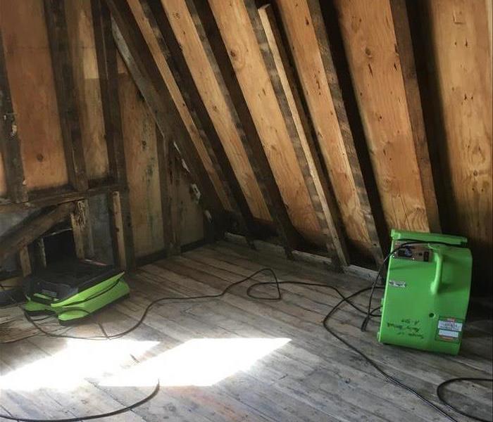 inside attic, bare wood, green devices drying