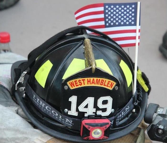 firefighter helmet with an American flag stuck in it